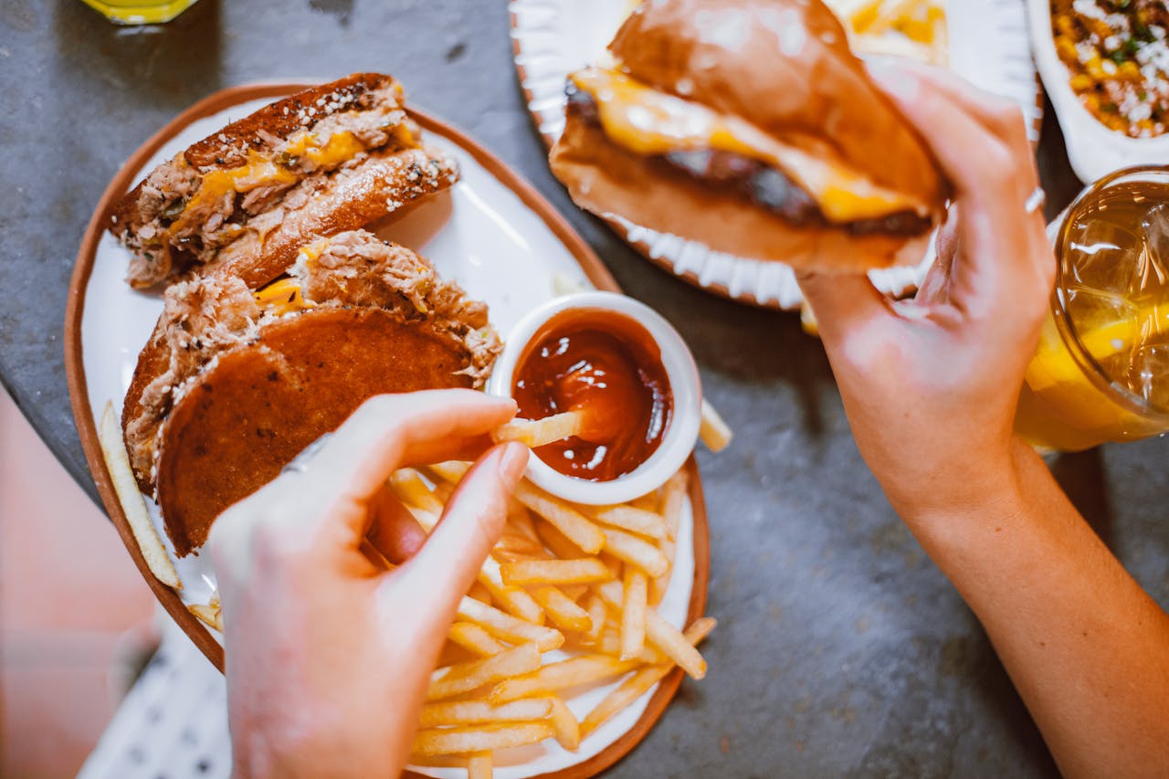 Mouth-watering fast food meal featuring burgers, fries, and refreshing drinks.